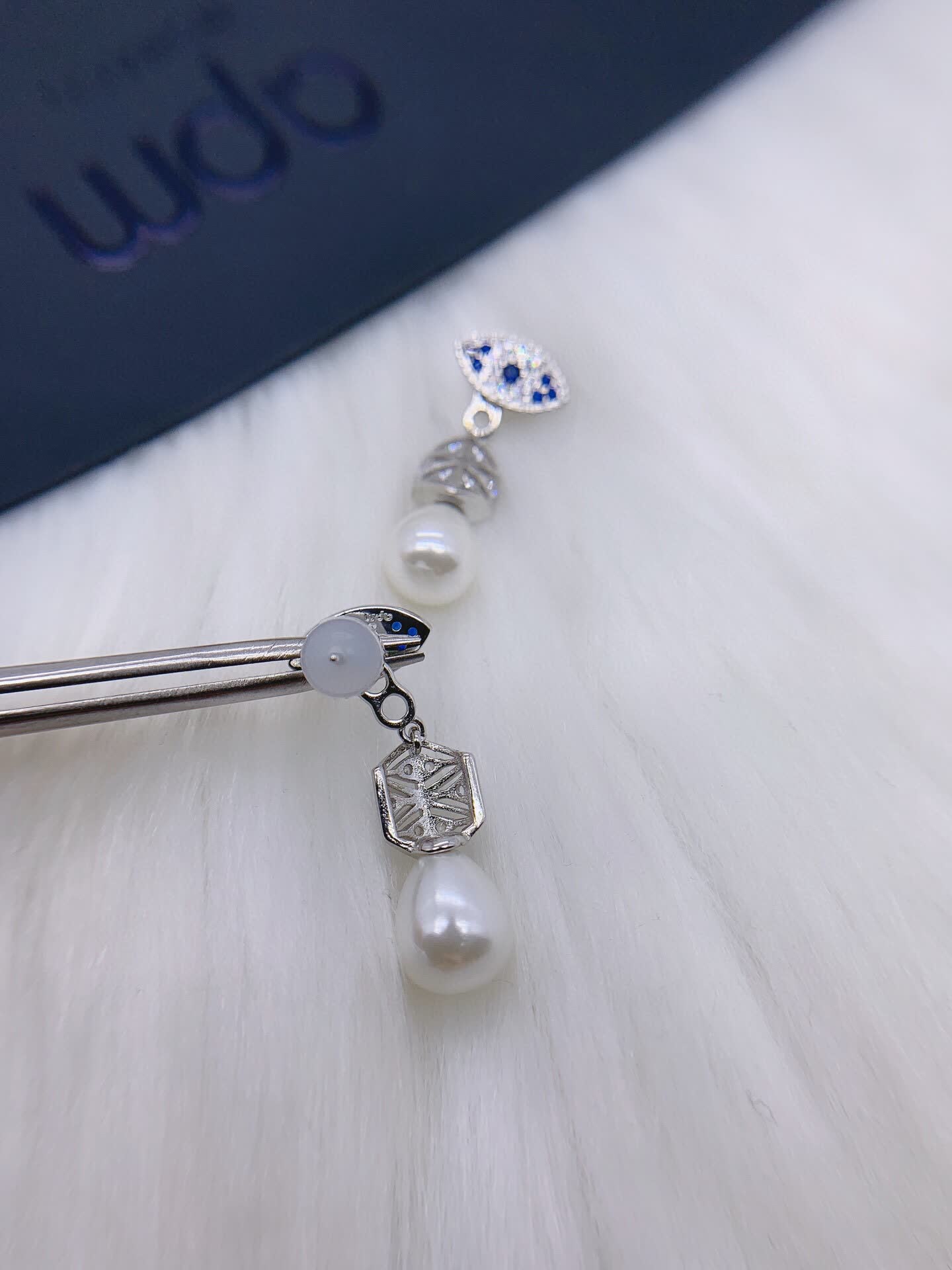 APM Monaco Elegant Pearl and Sapphire Eye Stud Earrings